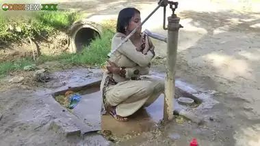 Young village school girl taking a bath in a sari and caught on camera